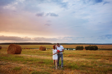 Naklejka na ściany i meble young loving couple on wheat field