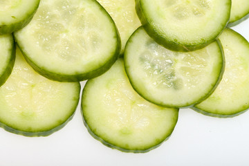 Freshly sliced cucumber  isolated on white background