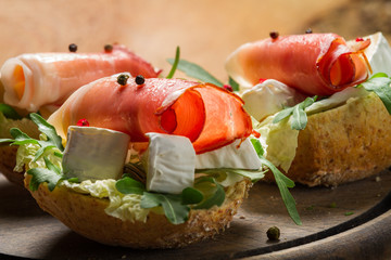 Two fresh sandwiches made of parma ham and brie cheese