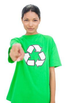 Relaxed model wearing recycling tshirt pointing at camera