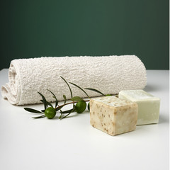 Handmade olive soap with olive branch and a towel.