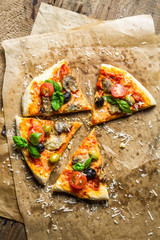 Homemade pizza with mushrooms on baking paper