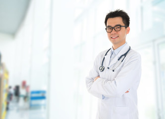 Asian doctor standing at hospital corridor