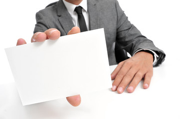 man in suit showing a blank signboard