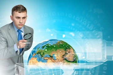 Man looking in magnifier