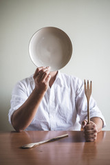 young stylish man with white shirt and dish in his face