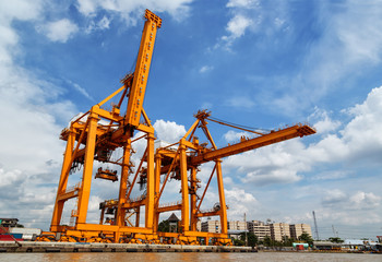 Fototapeta na wymiar Cargo ship at the port with blue sky
