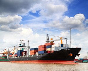 Cargo ship at the port outgoing with blue sky