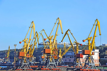 Port cargo crane over blue sky background