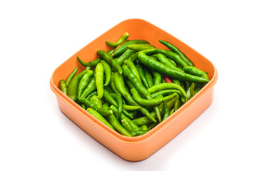 Green Chilli Peppers in box isolated on white