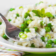 Italian risotto with rice, green peas, mint and cheese