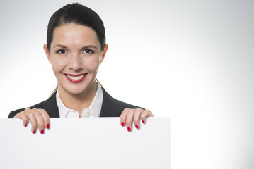Smiling businesswoman holding a blank board