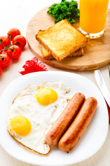 Fried eggs with sausages.