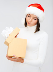 suspicious woman in santa helper hat with gift box