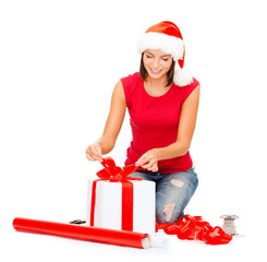 smiling woman in santa helper hat with gift box