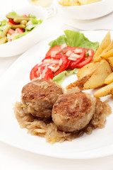 Meatballs with stewed onion and fried potato wedges
