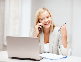 businesswoman with smartphone in office