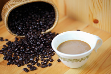 Coffee cup and coffee bean on a wooden table