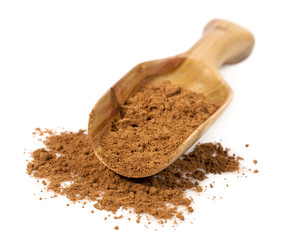cocoa powder in a wooden scoop