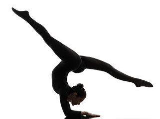 woman contortionist  exercising gymnastic yoga   silhouette