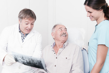 elderly gentleman, discussing with his dentist x-ray results