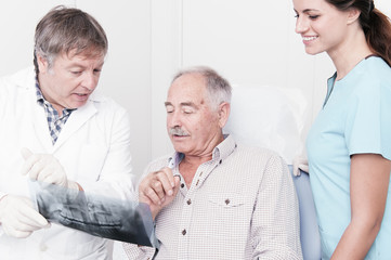 elderly gentleman, discussing with his dentist x-ray results