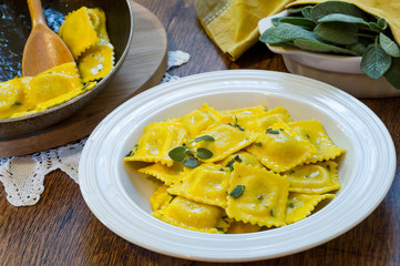homemade ravioli pasta with sage butter sauce , italian food