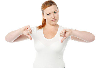 Young women showing thumbs down
