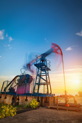 Pump jack on the sunset,long exposure
