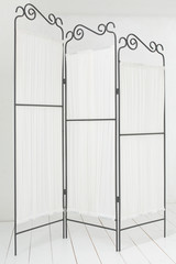 folding screen made ​​of metal and fabric in a light room