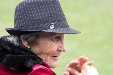 Senior woman with hat look ahead
