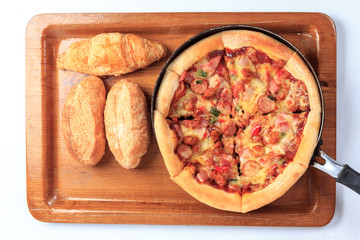 delicious pizza and bread on wooden background
