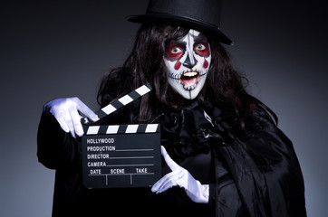 Monster with movie clapper board