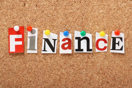 The word Finance on a cork notice board