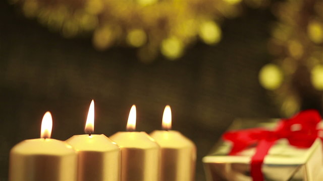 Panning over four advent candles at christmas