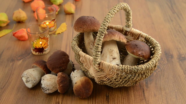 Basket with penny bun mushrooms with autumn decoration.