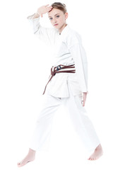Pretty young girl in karate uniform