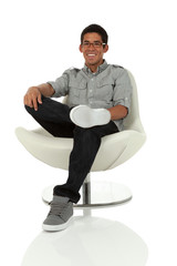 College age man relaxing in a modern chair