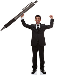 Business man celebrating holding a huge pen