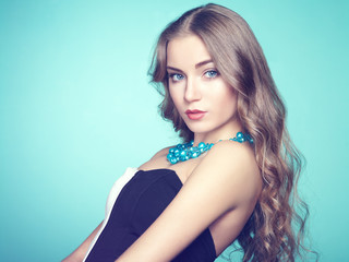 Naklejka premium Portrait of beautiful young blonde girl in black dress