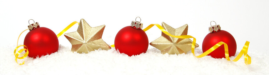 Red-golden baubles and golden stars on the snow