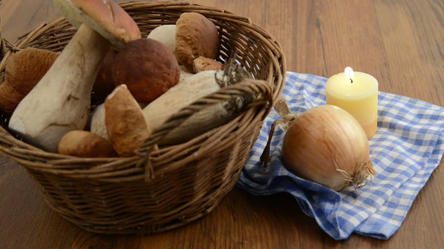 penny bun mushrooms in a basket and burning tea light