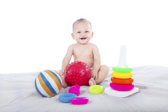 Cute baby with toys - isolated