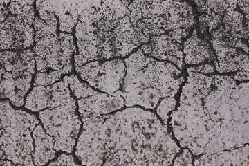 Asphalt road with many cracks