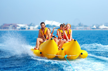 happy people having fun on banana boat © Olesia Bilkei