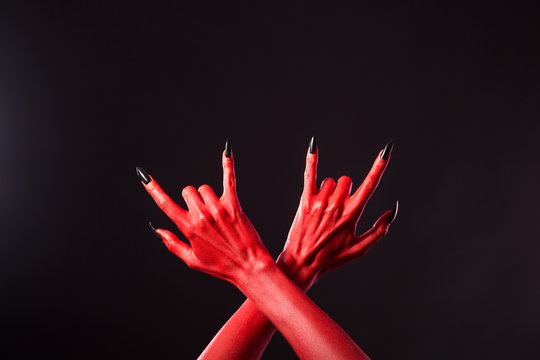 Red devil hands showing heavy metal gesture