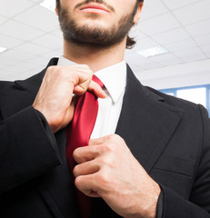 Businessman adjusting his tie