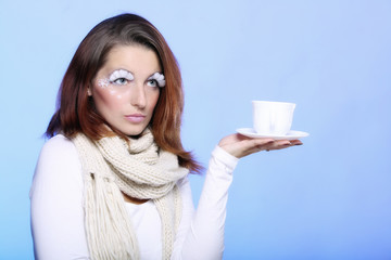 Winter makeup woman with cup of hot beverge