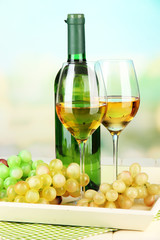 Fototapeta na wymiar Ripe grapes, bottle and glasses of wine