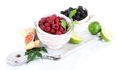 Raspberries and blackberry in small bowls
